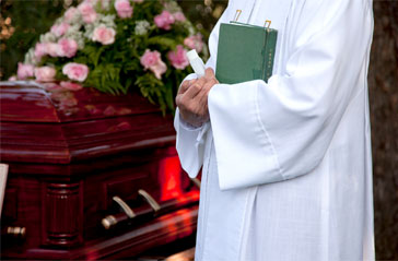 A pastor performing a funeral.